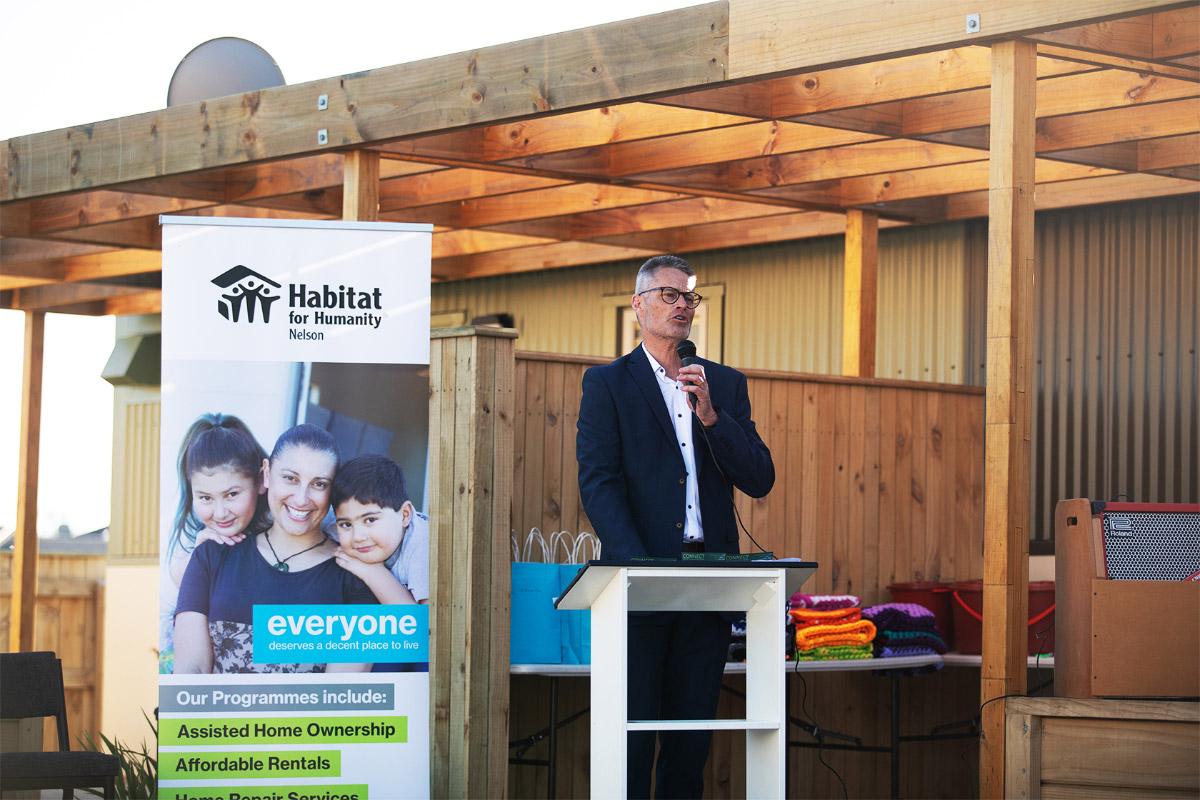 Nick Clarke speaks to the crowd about Habitat for Humanity's work and projects. Advocating for the need to help local families with housing need.