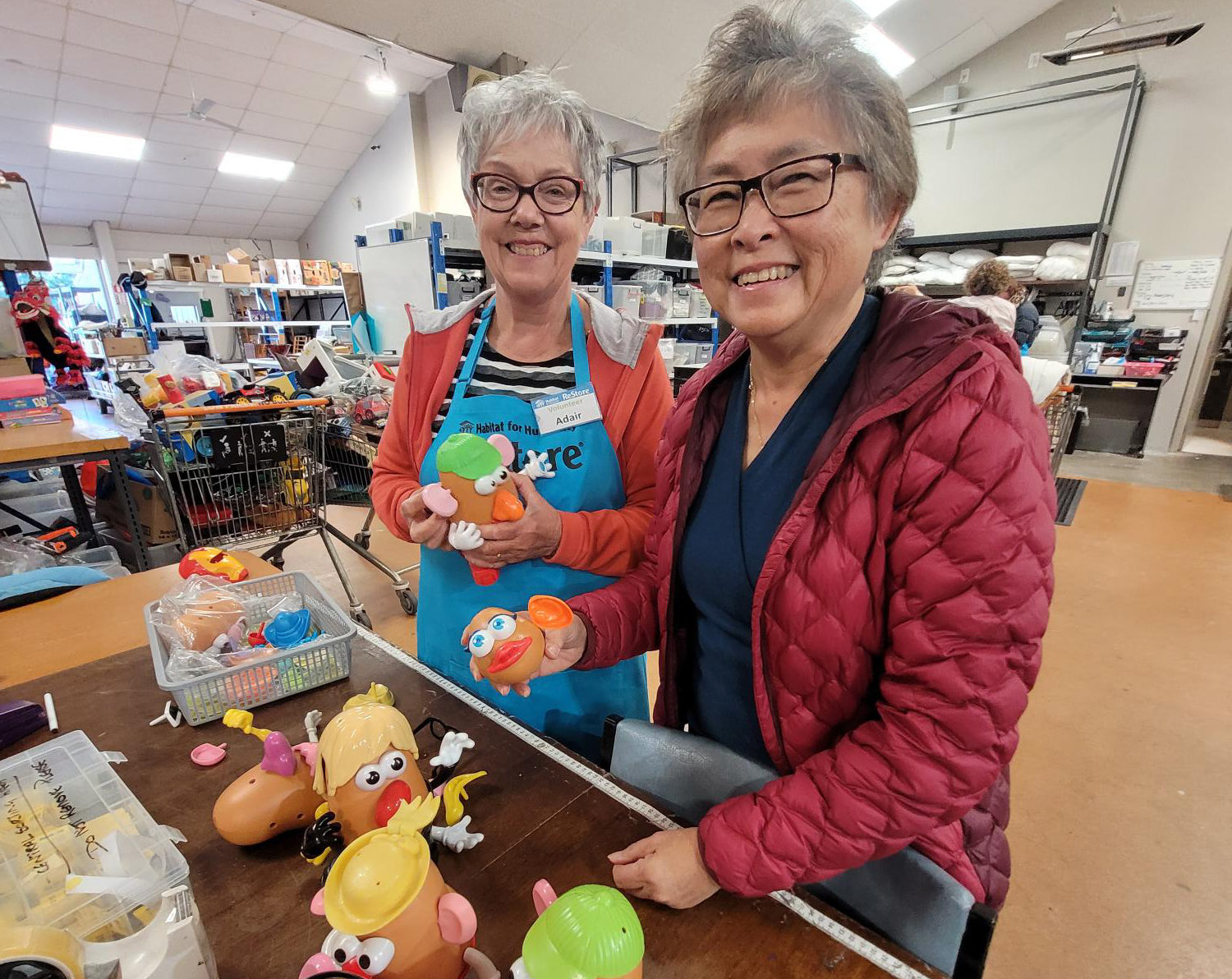 Female volunteers sort toys at ReStore Nelson
